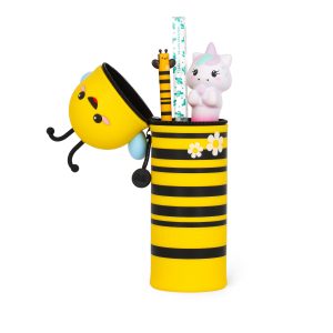 A product shot of a cute, bee-shaped pencil case by Legami, isolated on a white background. The yellow and black striped pencil case is standing upright with its zipped lid open. The lid, which forms the bee's head, is shown dangling at the side with a kawaii-style face. The open pencil case reveals a selection of stationery inside, including a pen with a bee topper and a small unicorn figure.