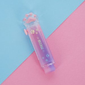 A translucent, retractable eraser with a cat paw design lying on a surface that is half light blue and half pink. The dispenser contains a pink and purple eraser and has silver cat paw prints and the word "meow" on its side. The top of the dispenser is a clear cat paw with pink toes and paw pad.