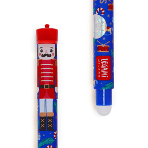 A close-up, cropped shot of two ends of a blue Legami erasable pen, part of the Christmas set. The top of the pen features a detailed illustration of a nutcracker with a red hat, black moustache, red jacket, and white pants on a blue background adorned with candy canes and snowflakes. The bottom of the pen has a Legami logo with a white eraser tip. It also has a round, holographic "LIMITED EDITION" sticker.