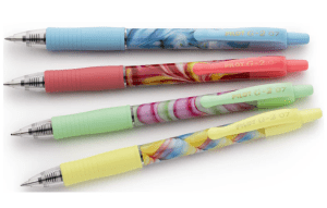 Four colourful Pilot G-2 07 retractable gel pens stacked horizontally against a white background. Each pen features a distinct pastel-coloured ribbed grip (blue, coral pink, mint green, and yellow) paired with a coordinating abstract marbled swirl design on the main barrel.