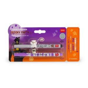 Retail packaging for the limited edition Legami Lovely Friends Spooky Party gel pen set against a purple and orange Halloween card with an admission ticket design. The pack contains two pens: a grey pen with a ghost bear topper and black ink, and a purple pen with a mummy cat topper and purple ink.